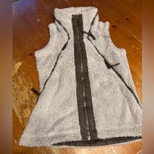 Super cute! Fluffy vest with a stowaway hood. Stone tan color.